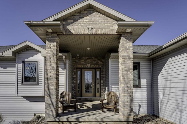 view of exterior entry featuring a patio area