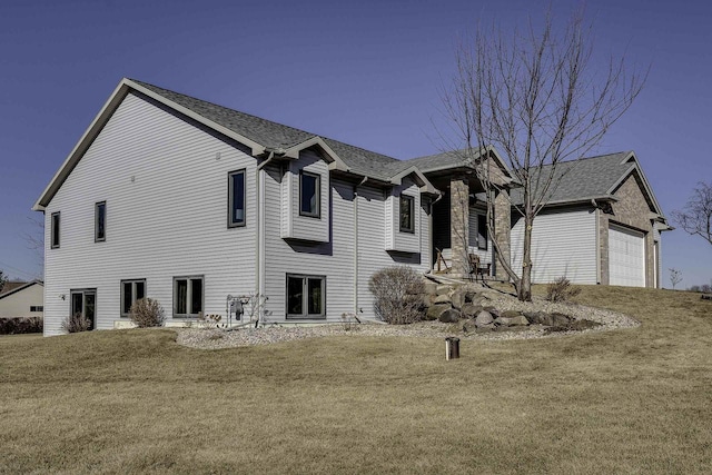 view of front facade with a garage and a yard