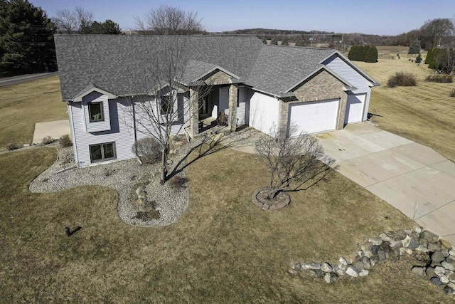 view of front of property featuring a garage and a front lawn