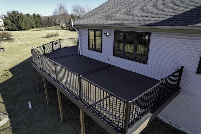 wooden terrace featuring a yard