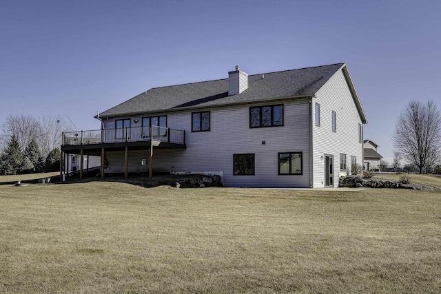 rear view of house featuring a yard