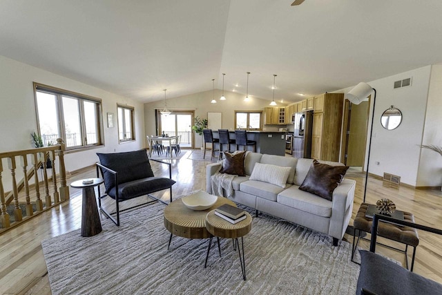 living room featuring vaulted ceiling and light wood-type flooring