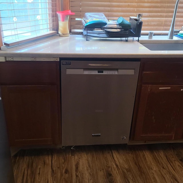 kitchen with sink, backsplash, stainless steel dishwasher, dark brown cabinetry, and dark wood-type flooring