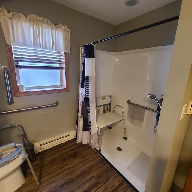 bathroom with a baseboard radiator, hardwood / wood-style floors, and a shower with shower curtain