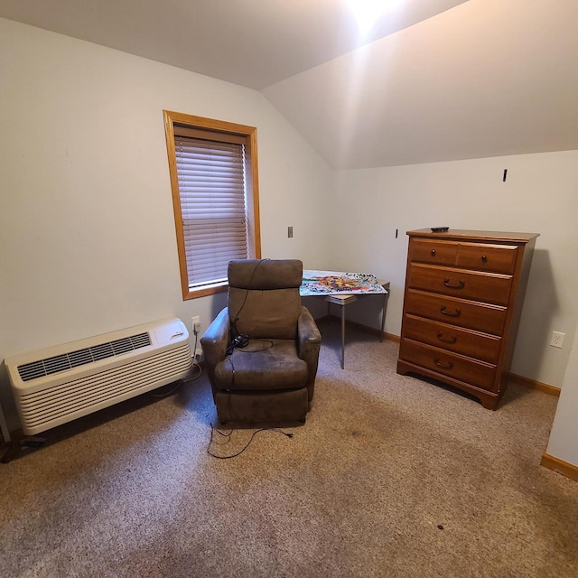 sitting room featuring vaulted ceiling, a wall mounted AC, and carpet