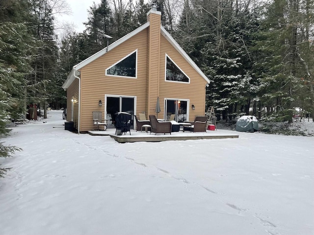 view of snow covered rear of property