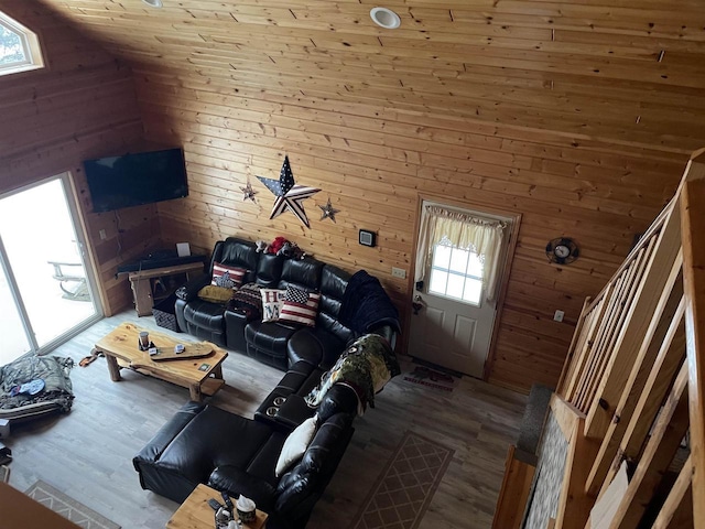 living room featuring hardwood / wood-style flooring and wooden walls