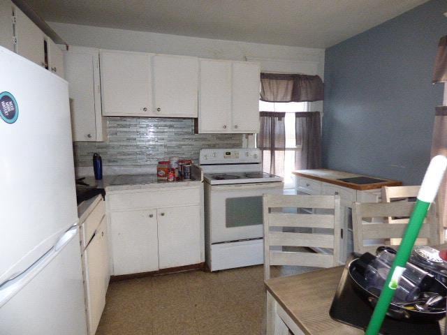 kitchen featuring white cabinetry, white appliances, and tasteful backsplash