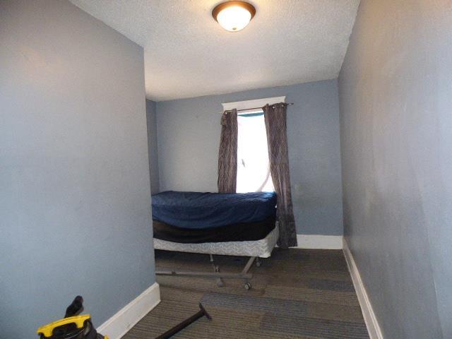 carpeted bedroom with a textured ceiling