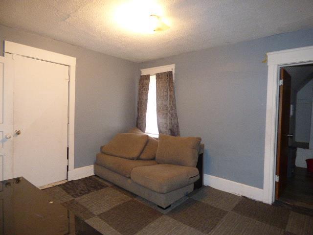 living room featuring a textured ceiling