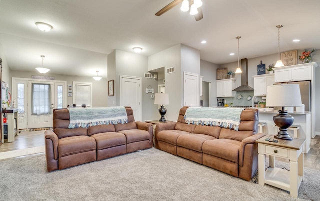 living room featuring ceiling fan and light hardwood / wood-style floors