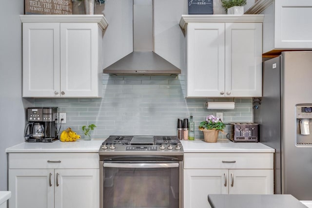 kitchen with white cabinetry, wall chimney range hood, and appliances with stainless steel finishes