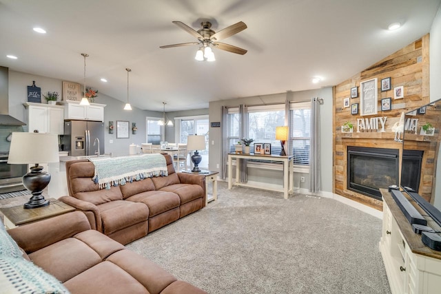 living room with lofted ceiling, light colored carpet, and ceiling fan