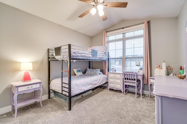 carpeted bedroom with ceiling fan and vaulted ceiling