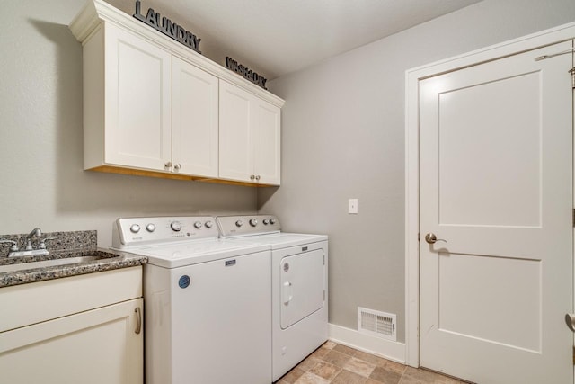 laundry area with cabinets, separate washer and dryer, and sink