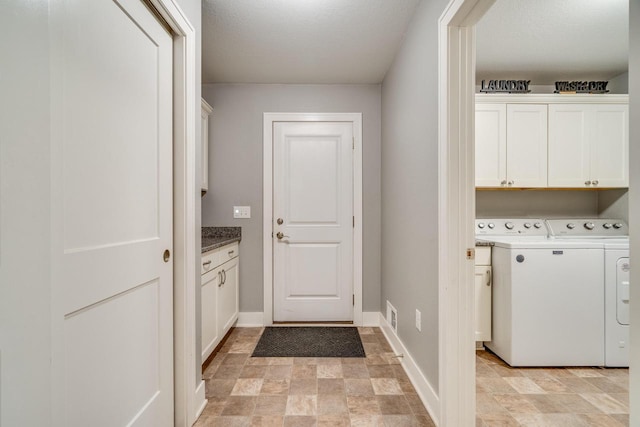 laundry area with cabinets and washing machine and dryer