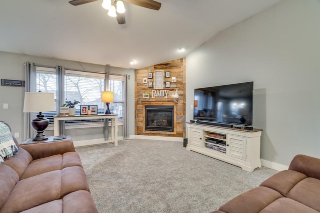 carpeted living room with a fireplace, vaulted ceiling, and ceiling fan