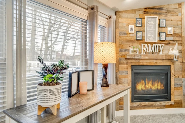 living area featuring lofted ceiling and wood walls