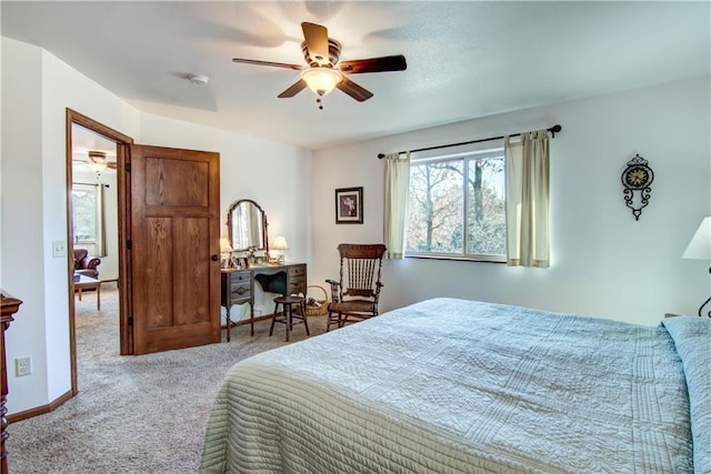 bedroom with ceiling fan and light colored carpet