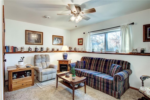 carpeted living room with ceiling fan