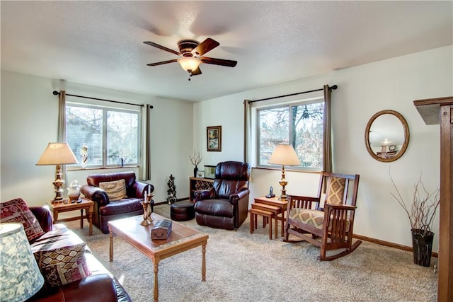 living room with plenty of natural light, light carpet, and ceiling fan