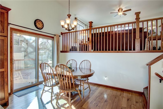 dining space featuring ceiling fan with notable chandelier and light wood-type flooring