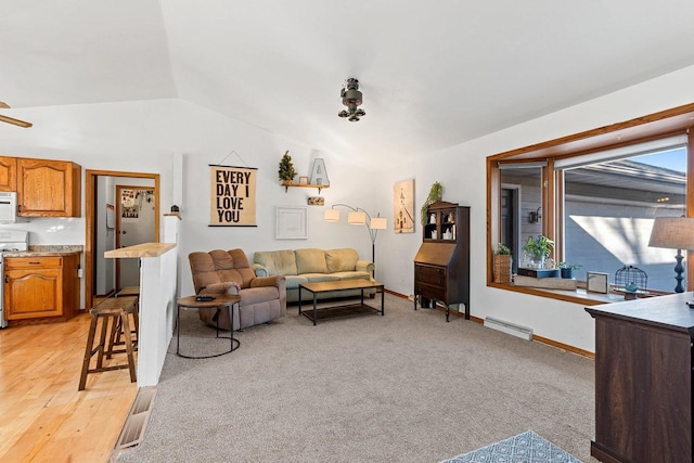 living room featuring vaulted ceiling, light colored carpet, and baseboard heating