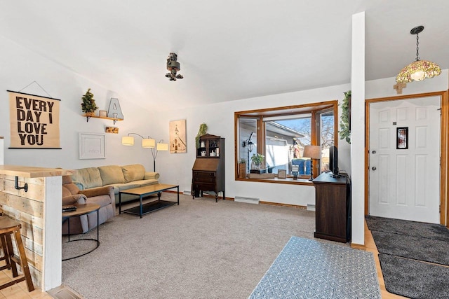 living room with vaulted ceiling and carpet