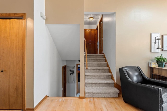 stairs featuring hardwood / wood-style floors