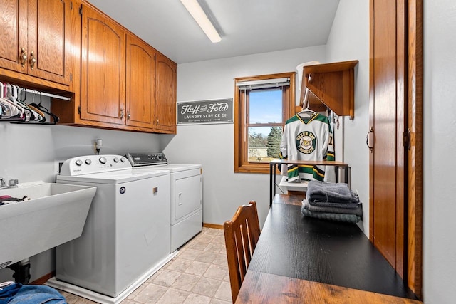 laundry room with washing machine and dryer and cabinets