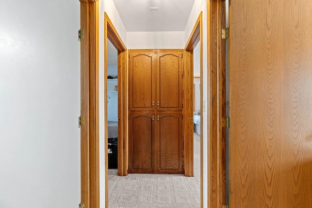 corridor with light colored carpet