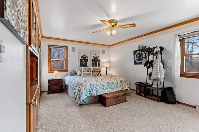 carpeted bedroom with ornamental molding and ceiling fan