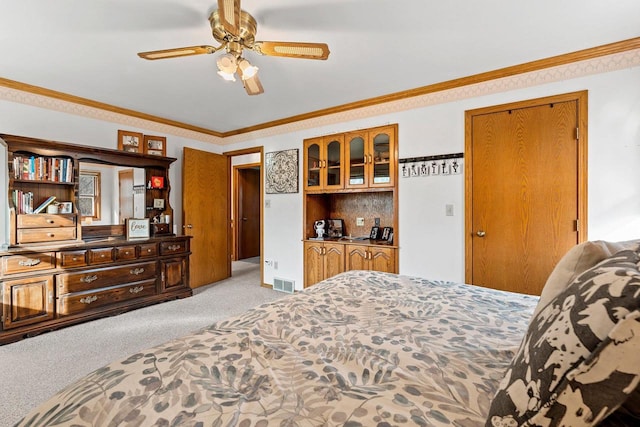 bedroom with crown molding, light colored carpet, and ceiling fan