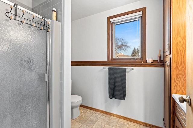 bathroom featuring toilet and walk in shower