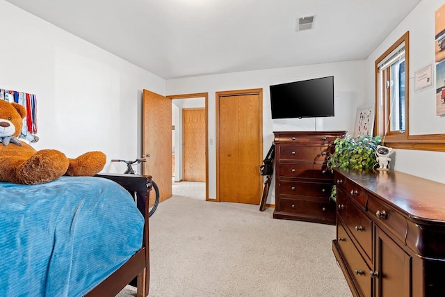 bedroom featuring light colored carpet