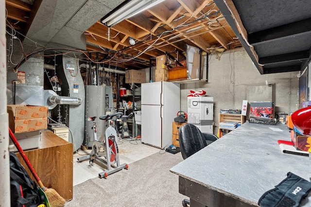 basement with gas water heater and white fridge