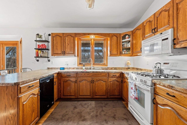 kitchen with sink, white appliances, and kitchen peninsula