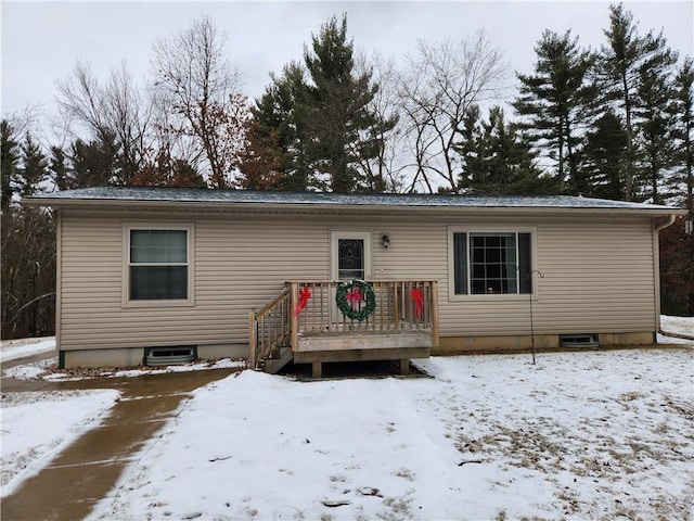 snow covered house with a deck