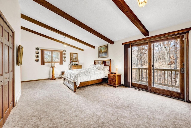 carpeted bedroom featuring multiple windows, access to exterior, lofted ceiling with beams, and a textured ceiling