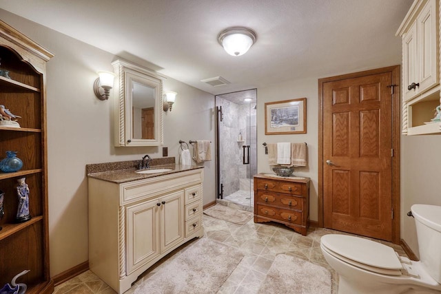 bathroom with vanity, toilet, and a shower with shower door