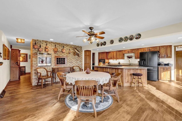 dining area featuring ceiling fan and light hardwood / wood-style floors