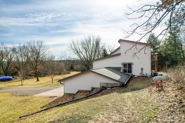 view of side of property with a lawn