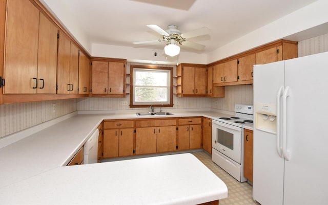 kitchen with ceiling fan, white appliances, kitchen peninsula, and sink