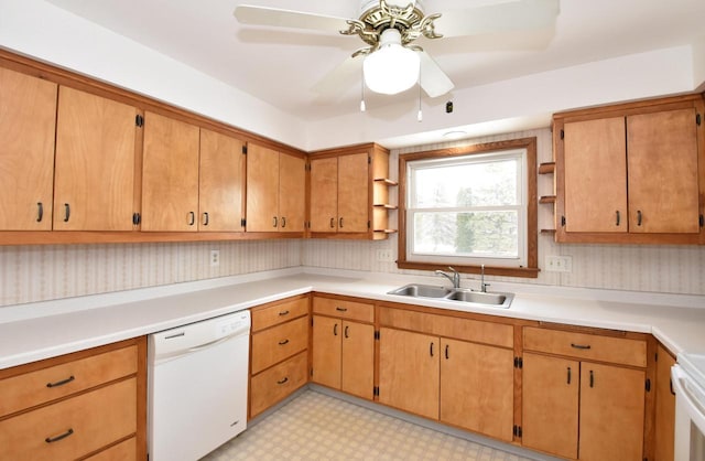 kitchen featuring ceiling fan, white dishwasher, and sink