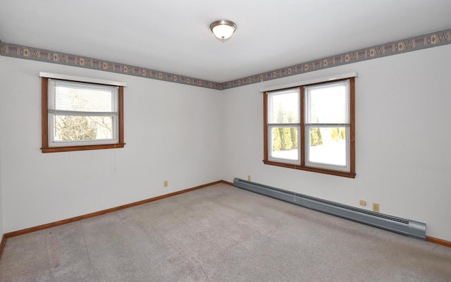 carpeted empty room with a baseboard radiator