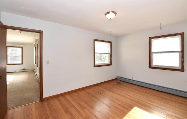 spare room featuring light hardwood / wood-style flooring and baseboard heating