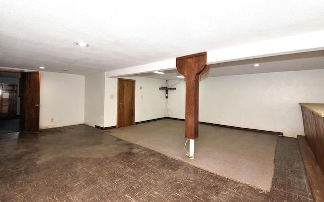 basement featuring a textured ceiling