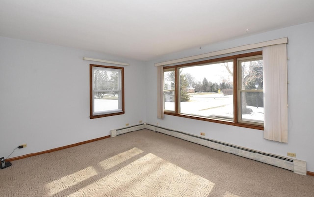 carpeted spare room featuring baseboard heating