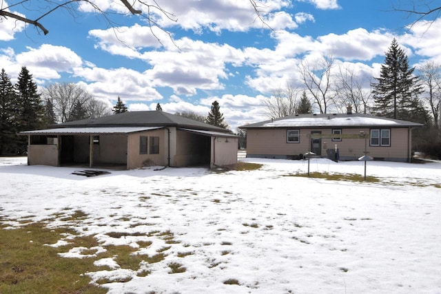 view of snow covered rear of property