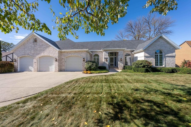 ranch-style home featuring a garage and a front yard